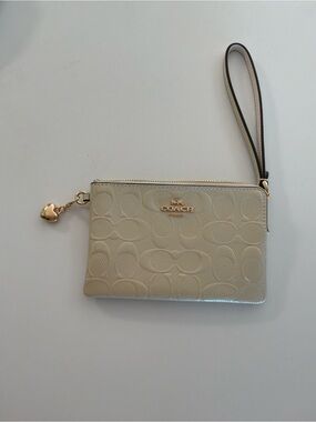 COACH Cream Signature Embossed Wristlet with Gold Charm